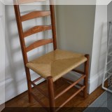 F42. Ladder back chair with rush seat. 41”h x 20”w x 15”d - $65 